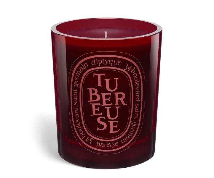Tubereuse Scented candle enclosed within a red colored hand-blown glass container by diptyque